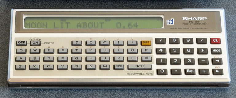 Photo of a Sharp PC-1211 running a moon phase calculation program