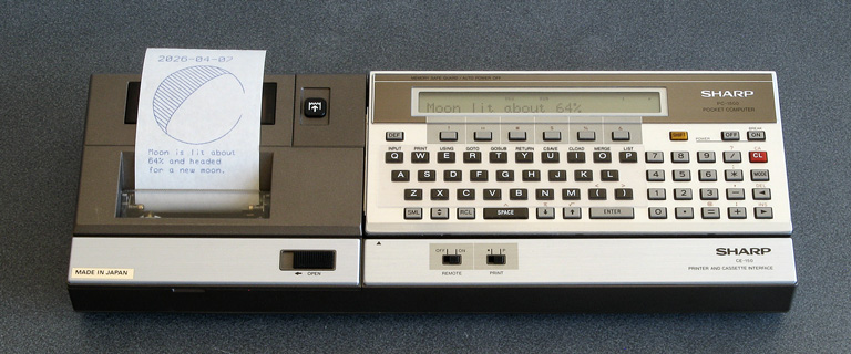 Photo of a Sharp PC-1500 running a moon phase calculation program