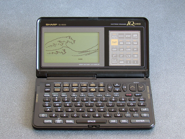 Photo of a Sharp IQ-8000 displaying the Great Wave as rendered as a fractal from a BASIC program