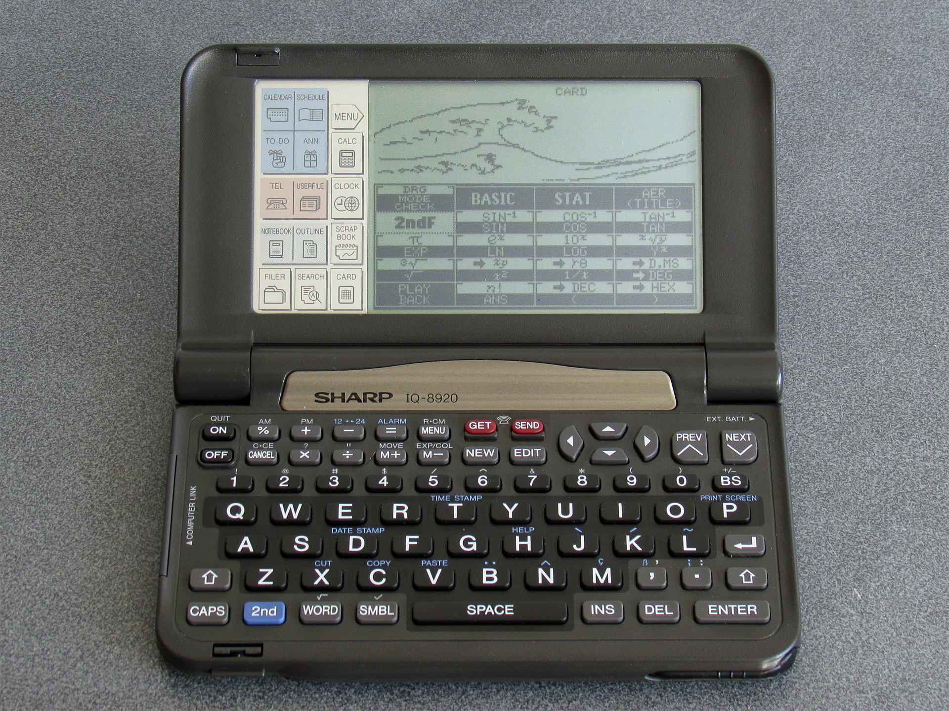 Photo of a Sharp IQ-8920 displaying the Great Wave as rendered as a fractal from a BASIC program