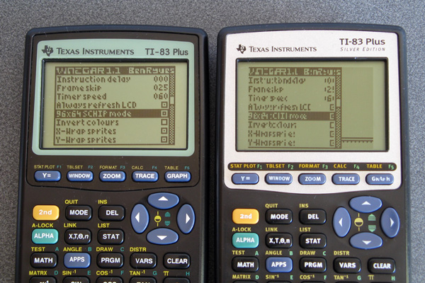 Photo of a TI-83 Plus next to a TI-83 Plus Silver Edition, with the display on the latter calculator showing a distorted and corrupt version of the intended image shown on the former.